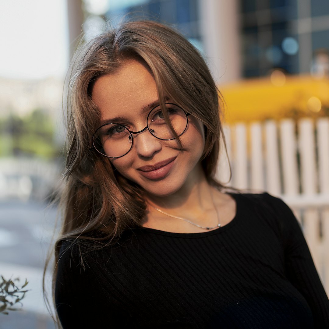 Portrait of a young Chilean woman with glasses smiling